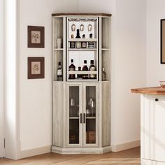 a corner cabinet with liquor bottles and glasses on it's shelves in a living room