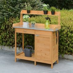 an outdoor potting bench with plants on top