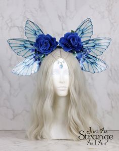 A real must-have statement crown for all fairies! A beautiful deep blue rose flower fairy headdress. The wings are lightweight and far more durable than their glassy appearance might suggest! They are backed with wire, which is what gives them their gorgeous curve. They are flexible to touch, and may be very slightly adjusted to give a deeper/more shallow curve. The headdress is decorated with blue roses and blue blossoms. Sparkling Swarovski beads hang over the forehead from a silver chain. The Blue Fairy Costume, Blue Fairy Wings, Butterfly Headpiece, Butterfly Crown, Wings Dress, Fairy Crown, Fantasy Dresses, Blue Wings, Blue Fairy