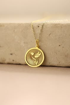 Gold Hummingbird Pendant - Hummingbird Gold Necklace ● Material of pendant: Solid Gold 14k ( REAL GOLD ) ● Metal Stamp: 14k ( REAL GOLD ) ● The pendant is available in 5 sizes: - 12,7 mm / 0.5 inches (Diameter) - 14,0 mm / 0,55 inches ( Diameter ) In the photos - 15,3 mm / 0.6 inches ( Diameter ) - 16,5 mm / 0,65 inches ( Diameter ) - 19,1 mm / 0,75 inches ( Diameter ) ( In the photos the size is 14mm / 0.55 inches Diameter ) ( Jump Ring inner diameter: 4 mm ) ● Material of chain: Solid gold 14k Gift Jewelry With Bird Design Round Pendant, Round Pendant Jewelry With Bird Design For Gift, Bird Design Round Pendant Jewelry As Gift, Bird Design Round Pendant Jewelry For Gifts, Bird Design Round Pendant Jewelry Gift, Necklace With Round Pendant And Bird Design For Gifts, Round Pendant Necklace With Bird Design For Gift, Round Necklace With Bird Design For Gift, Bird Design Necklace Gift