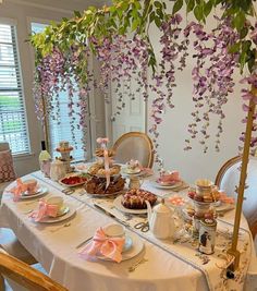 the table is set with tea and desserts