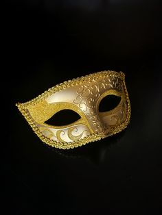 Crafted in gold, this mask is not just an accessory; it's a symbol of sophistication that will leave a lasting impression. Whether you're attending a masquerade ball, a gala, or a special celebration, make a statement that resonates with sophistication and charm.


Age Group/Gender - Adult/Men

Size/Type - One size fits all adults

Mask Color - Gold

Mask Material - Polyresin

Accent Material - Glitter Luxury Gold Masks For Party, Luxury Gold Masks And Prosthetics For Theater, Elegant Silver Evening Masks, Halloween Evening Masquerade Mask, Carnival Evening Masquerade Eye Mask, Gold Masks For Halloween Costume Party, Gold Venetian Masquerade Mask For Halloween, Venetian Gold Masquerade Mask For Halloween, Gold Venetian Mask For Halloween