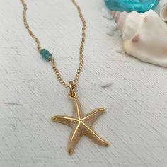 Calling all ocean lovers! This gorgeous golden starfish is perfect for you. Set off your summer tan with a gorgeous enamel accented starfish charm accented beautifully with 3 blue topaz stones. Starfish charm measures approximately 1 inch in diameter. 14kt gold fill chain accented with genuine blue topaz stones. Ocean-inspired Jewelry With Star Charm, Turquoise Ocean-inspired Jewelry With Starfish Charm, Beach Jewelry With Starfish Charm, Ocean-inspired Star Charm Jewelry, Gold Starfish Charm Jewelry For Beach, Gold Beach Jewelry With Starfish Charm, Gold Jewelry With Starfish Charm For Beach, Ocean-inspired Gold Jewelry With Starfish Charm, Yellow Gold Starfish Jewelry In Ocean-inspired Style