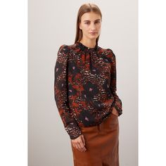 Brown floral chiffon (100% Recycled Polyester). Top. Long sleeves. Mock neck. Pull on. Imported. Chic Tops With Floral Print And Bishop Sleeves, Ruffled Puff Sleeve Top For Work In Fall, Puff Sleeve Top With Ruffles For Work In Fall, Fall Ruffled Puff Sleeve Top For Workwear, Fall Floral Print Long Sleeve Puff Sleeve Top, Floral Print Puff Sleeve Top For Work, Puff Sleeve Floral Print Top For Work, Chic Puff Sleeve Top With Floral Print, Fall Printed Blouse For Workwear