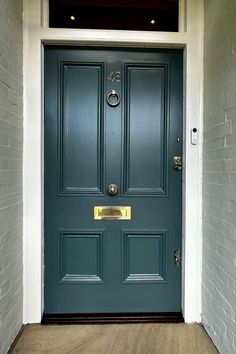 a blue door with two gold handles on it