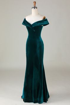 a green velvet evening gown on a mannequin