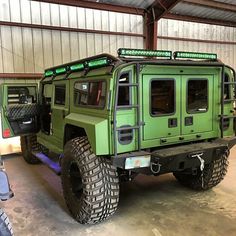 a large green truck parked in a garage