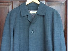 "This is a beautiful, high quality retro coat in dark gray color, length 40\" (102 cm) Labelled materials: 45% Wool, Viscose lining. Liner removed. * Wide shoulders * Button closure  * Two outside pockets + one inside Tags: Mr Togg especially made for DETEX AB Kamgarn Trevira Med 45% Ull DRY CLEAN ONLY In excellent condition. Comes from smoke-free home. Size L  Please check the measurements accurately. Measurements: Shoulders - Raglan sleeve length: ~ 31 1/2\" (80 cm) from a neckline Armpit to armpit: ~23\" (58cm) Chest: ~46\" (116 cm) Length: ~ 40\" (102cm) Weight ~1.1 kg Thanks for visiting my shop! OLaLaVintage" Vintage Dark Wash Long-sleeved Outerwear, Vintage Single-breasted Wool Coat With Long Sleeves, Gray Single-breasted Vintage Outerwear, Vintage Blue Single-breasted Outerwear, Retro Coat, Dark Grey Color, Dark Gray, Mens Coats, Raglan Sleeve