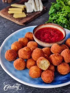 a plate with some food on it next to other foods and veggie sticks