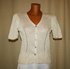 ❤️Beautiful Vintage 80s, Blouse with short sleeves, v neck,  buttons row, in beige color. A timeless gift! 55% viscose 45 % linen -Made in Italy Size : 40/ 42 Italian Dimensions: Shoulder to shoulder 34 cm. Breast 44 cm. 53 cm long Hand wash, cold water. Good vintage condition, from Italy ❤️If you love real vintage, take a look at my sister and friend shop !! Enjoy!! www.etsy.com/it/shop/TheReaItalianVintage www.etsy.com/it/shop/DreamInTheDrawer www.etsy.com/it/shop/Reinayestrellas Customer sati Retro Beige V-neck Top, Vintage Beige V-neck Top, Vintage Cream Blouse For Summer, Vintage Short Sleeve Beige Blouse, Classic Cream V-neck Blouse, Fitted Vintage V-neck Blouse, Vintage Beige Blouse With Short Sleeves, Vintage Beige Short Sleeve Blouse, Classic V-neck Cream Blouse