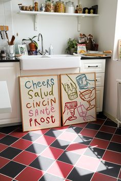 a kitchen with two signs on the floor