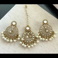 This A Beautiful And Elegant Mirror/Gold/Pearl Earrings And Matching Maang Tihka. Brand New Elegant Beaded Pearl Earrings For Festive Occasions, Elegant Beaded Bridal Earrings For Festivals, Pearl Earrings With Stone Work For Wedding, Wedding Pearl Earrings With Stone Work, Bollywood Style Pearl Chain Earrings As Gift, White Pearl Chandbalis, Bollywood White Pearl Chain Earrings, Elegant Mirror Work Earrings For Party, White Bollywood Earrings With Pearl Chain