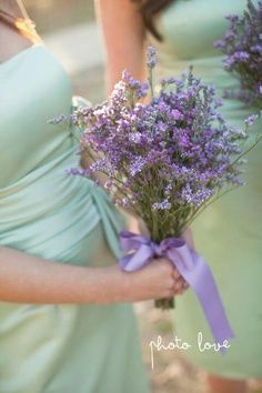 the bridesmaids are holding lavender flowers in their hands