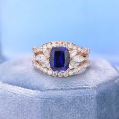 Model 511-9x7mmCushion Shape Sapphire Engagement ring with Pear Shape Accents Stones Ring.Setting:14K Rose Gold(Available in Yellow Gold and Rose Gold)Center Stone:2 Carat - 9x7mm Cushion Cut Lab Grown SapphireColor: Royal BlueClarity: VVS1Side Stones: Marquees MoissaniteColor: D-FClarity: VS2-Si1Cut: ExcellentThe total approximate weight of side stones: 0.7ctwShank width: 2mm As well please remember it takes up to 21 days to make and ship this item. Sapphire Engagement Ring Marquise, Sapphire Vintage Engagement Ring, Engagement Ring Cushion, Engagement Ring Marquise, Rose Gold Ring Set, Bezel Set Engagement Ring, Vintage Engagement Rings Sapphire, Diamond Anniversary Bands, Engagement Rings Cushion