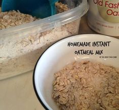 a bowl filled with oatmeal next to a container of yogurt