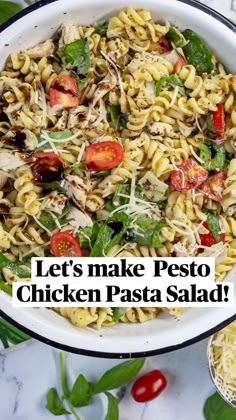 pasta salad with chicken and tomatoes in a white bowl