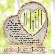 a heart shaped memorial with candles in it and a poem written on the front side