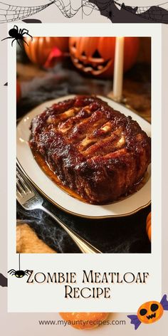 a plate topped with meat covered in sauce next to a candle and some pumpkins