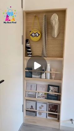 an open bookcase with books and pictures on the wall next to a white door