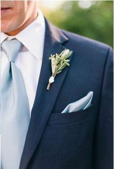 a man in a suit with a boutonniere on his lapel