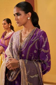 Purple silk organza A-line short kurta with vintage zardosi embroidery. Comes with pant and a slate grey dupatta. Components: 3 Pattern: Embroidered Type Of Work: Zardosi Neckline: V Neck Sleeve Type: Bell Sleeves Fabric: Silk organza Color: Purple Other Details:  Emboidered dupatta Note : Outfit worn by the model on the left is not for sale. Occasion: Mehendi and Haldi - Aza Fashions Celebration Organza Palazzo Set With Sheer Dupatta, Party Kurta In Organza With Cutdana Detailing, Party Kurta With Cutdana On Organza, Party Organza Kurta With Cutdana, Traditional Drape Dupatta With Kora Details, Organza Palazzo Set For Diwali Celebration, Party Palazzo Set In Organza With Cutdana, Organza Palazzo Set For Eid Celebration, Party Palazzo Set With Cutdana In Organza