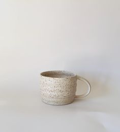 a white cup with speckles on it