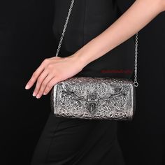 Size:   Height- 5 Inch, Width - 9 Inch, Depth - 3 inch  Weight - 625 grams Introducing our stylish and versatile metal silver sling bag. Perfect for both casual and formal occasions, this bag is a must-have for anyone who wants to make a statement with their accessories. Crafted from high-quality, durable metal, this bag has a sleek silver finish that catches the light beautifully Made by Brass Metal and Silver Coated, Inner side is Velvet coated and bag have Hanging Chain with it. Handmade Vintage Hand Clutch made from Brass Metal . A basic Brass metal object is fist designed and fine carving is done on it by hand. The process is finally completed by oxidization and polishing. The clutch is fixed with Metal Chain and the opening is big enough and the wall of the inner space is also fixed Silver Handmade Clutch As Gift, Handmade Silver Clutch As Gift, Traditional Silver Clutch As Gift, Handmade Silver Clutch For Gift, Traditional Handmade Silver Evening Bag, Handmade Silver Shoulder Bag, Handmade Silver Shoulder Bag As Gift, Handmade Silver Rectangular Clutch, Handmade Bohemian Silver Bag