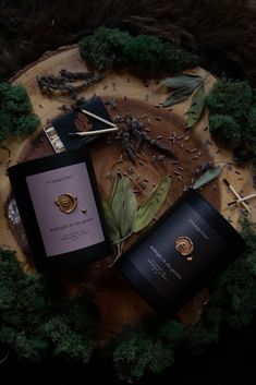 an open book sitting on top of a wooden table next to green leaves and twigs