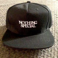 Nothing Special Snapback Black Snapback Baseball Cap With Letter Print, Casual Black Snapback Hat With Letter Print, Black Adjustable Snapback Hat With Letter Print, Adjustable Black Snapback Hat With Letter Print, Urban Black Snapback Hat With Letter Print, Black Letter Print Trucker Hat Flat Cap, Black Casual Snapback Hat For Streetwear, Black Snapback Hat With Letter Print And Flat Brim, Black Baseball Cap With Flat Bill For Spring