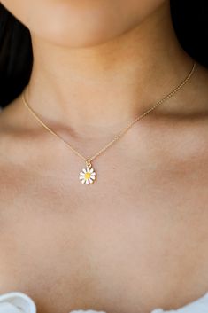 Finish any 'fit in iconic style when you add the Kenna Gold Daisy Charm Necklace! This cute necklace features a simple gold chain with a white daisy charm on the end. Style the Kenna Necklace with any outfit to instantly upgrade your look! Gold Plated White Daisy Charm Lobster Clasp + Extender One Size | Length 8” + 3" Extender Dainty White Necklaces For Spring, Dainty White Necklace For Spring, Cute White Necklaces For Spring, Everyday Flower Pendant Necklace, Cute Gold Jewelry For Spring, Everyday Daisy-shaped Jewelry For Spring, Everyday Daisy-shaped Spring Jewelry, Trendy White Flower Necklace As Gift, Trendy White Flower Necklace Gift