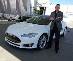 a man standing next to a white car