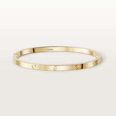 Cartier - LOVE bracelet, small model - Bracelet Woman Gold - LOVE bracelet, small model, 18K yellow gold (750/1000). Sold with a screwdriver. Width: 3.65 mm (for size 17). The iconic LOVE bracelet has been a symbol of free-spirited LOVE since 1969. Its screw motif and famous locking technology are truly timeless design signatures, while its oval shape ensures a close but comfortable fit to the wearer’s wrist. The locking mechanism consists of a single functional screw on one side of the bracelet Bracelet Cartier, Cartier Gold, Cartier Bracelet, Bracelet Love, Cartier Jewelry, Love Bracelet, Gold Bracelet For Women, Cartier Love