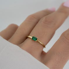 Beautifully crafted emerald ring is a true stunner! Looks great stacked or on its own! - - - D E T A I L S - - -  * Made of 925 Sterling Silver * We use a THICK plating of 14k Gold or Rhodium * Available in sizes 4-10 * 3x5mm Baguette Stone * Nickel-free & Hypoallergenic - Will not turn your fingers green! * Made of the highest grade cubic zirconia for an authentic look! * Also available in White Cubic Zirconia  https://www.etsy.com/listing/1327774787/baguette-ring-dainty-stacking-ring?click_key=1cbb852cd51339c29f8a763fa5c7a3085b2fd29f%3A1327774787&click_sum=b630e565&ga_search_query=baguette%2Bring&ref=shop_items_search_19&pro=1&sts=1 If you're unsure of your ring size, we recommend trying our ring size tool! https://www.etsy.com/listing/1240904225/ring-sizer-reusable-ring-sizer-plastic?cl Gold Emerald Ring Engagement, Stackable Green Emerald Diamond Ring, Green Emerald Stackable Diamond Ring, Green Emerald Solitaire Crystal Ring, Stackable Emerald Cut Emerald Ring, Stackable Green Emerald-cut Diamond Ring, Stackable Emerald Promise Ring, Dainty Emerald Rings With Emerald Cut, Stackable Emerald Cut Green Diamond Ring