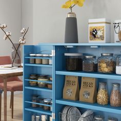 a blue book shelf filled with lots of different types of food and containers on top of it