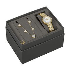 a watch and bracelet in a black box with gold jewelry on the inside is shown