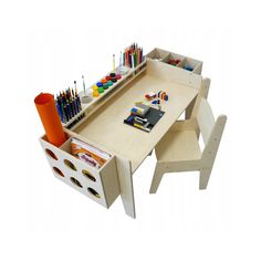 a child's desk and chair with art supplies on the top, along with an organizer for pens and pencils