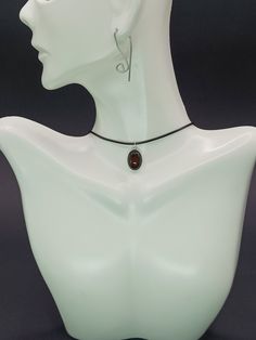 "This exquisite pendant featuring carnelian set in sterling silver indeed embodies both elegance and a vibrant energy. Carnelian, known for its deep, rich hues ranging from orange to reddish-brown, has been cherished through the ages, not only for its beauty but also for its supposed healing properties and ability to inspire courage and creativity. The choice of sterling silver for the frame enhances the warm glow of the carnelian, creating a striking contrast that highlights the stone's natural beauty. This piece of jewelry goes beyond mere adornment; it serves as a talisman of positivity and style. Its timeless design ensures it will be a cherished part of any collection, appealing to those who appreciate the deeper meaning and history behind their accessories.  Note: Keep in mind that t Adjustable Wire Wrapped Teardrop Pendant Necklace, Adjustable Teardrop Pendant Necklace With Wire Wrapped, Nickel-free Brown Necklace For Gift, Minimalist Amber Round Pendant Jewelry, Amber Crystal Necklace For Gift, Nickel Free Adjustable Necklace For Formal Occasions, Minimalist Adjustable Oval Necklaces, Adjustable Nickel-free Necklace For Formal Occasions, Adjustable Nickel Free Necklace For Formal Occasions