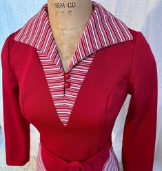 "Like new! The V of stripes on the hips is so attractive... the photos that are more burgundy are more true to life. Clean and ready to wear! Measurements of the dress taken flat (double where necessary): Pit to pit across front 17\" Waist 14.5\" Hips 20\" Back of neckline to hem 40\" Shoulder to shoulder 14.5\" Armpit to waist 7\" Side waist to hem 26\" Across hem 33\" Please note that I don't accept returns if the item doesn't fit, unless I've made a huge mistake in the measurements or description. Please make sure to read the description and check the measurements carefully against a similar item that fits you well!" Striped Fitted V-neck Dress, Fitted Striped V-neck Dress, Striped V-neck Fitted Dress, Vintage Striped Fitted Dress, Fitted Retro Dresses With Vertical Stripes, Retro Fitted Dress With Vertical Stripes, Fitted Striped Dress For Fall, Striped Fitted Dress For Fall, Fitted Long Sleeve Dresses With Vertical Stripes