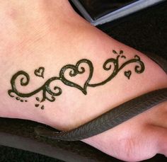 the foot is decorated with two hearts and swirls on it's side, as well as a snake