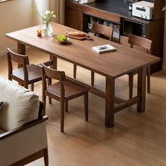 a wooden table with chairs around it in a living room