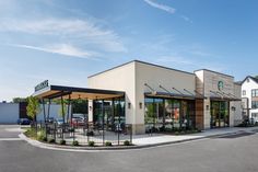 the outside of a restaurant with tables and chairs