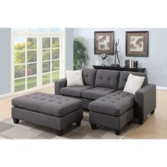 a living room with a gray couch and ottoman