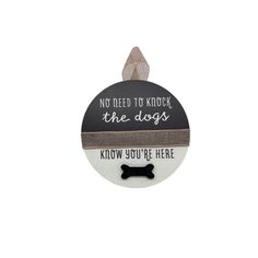 a black and white ornament with a dog's name on it, says no need to kick the dogs know you're here