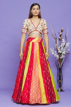 Multicolor bandhani lehenga with contrast woven floral motifs. Comes with white blouse with all-over sequin, French knot and thread embroidery.
Component: 2
Pattern: Embroidery
Type Of Work: Thread, Sequin and Woven Floral Motifs
Neckline: V neck
Sleeve Type: Half
Fabric: Pure Bandhani
Color: Multi Color
Other Details: 
Cutout detail at the waist and back
Kalidar lehenga
Lehenga with tie up on the side
Closure: Blouse: Metallic buckle
Occasion: Sangeet - Aza Fashions Fitted Multicolor Pre-draped Saree For Eid, Multicolor Bandhani Print Pre-draped Saree For Wedding, Multicolor Choli With Resham Embroidery For Reception, Multicolor Resham Embroidery Choli For Reception, Multicolor Pre-draped Saree With Dori Work For Designer Wear, Multicolor Pre-draped Bandhani Saree For Transitional Season, Multicolor Saree Set For Reception, Fitted Multicolor Silk Choli, Festive Multicolor Pre-draped Saree With Resham Embroidery