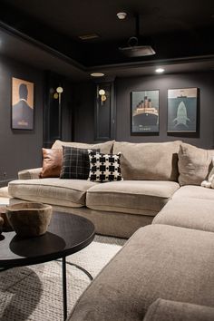 a living room filled with furniture and pictures on the wall