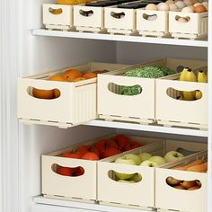 an open refrigerator with bins filled with fruits and vegetables