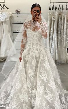 a woman taking a selfie in her wedding dress