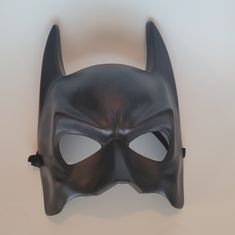 a black batman mask on a white background