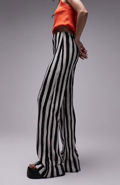 Bold stripes draw attention to these wide-leg trousers that add instant style points to in-office or off-duty looks. 100% polyester Machine wash, line dry Made in the UK Striped Full-length Bottoms For Work, Chic Pants With Contrast Stripes, Chic Trousers With Contrast Stripes, Elegant Wide Leg Pants With Vertical Stripes, Elegant Wide Leg Trousers With Vertical Stripes, Elegant Striped Wide-leg Pants, Chic Striped Full-length Bottoms, Chic Striped High-waisted Wide Leg Pants, Chic Striped Pants For Night Out