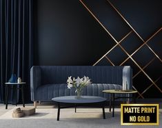 a living room with black walls and gold trimmings on the wall, blue velvet couch